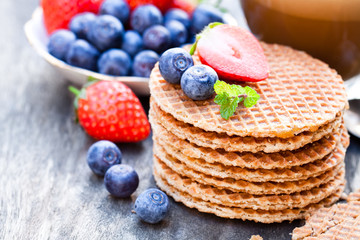 Stack  of Dutch caramel waffles with blueberry and strawberry wi