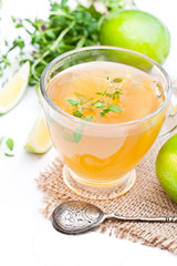 Green  tea with thyme and lime on white background