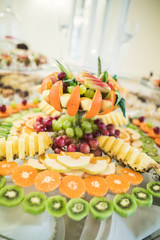 Various sweet sliced fruit on a buffet table