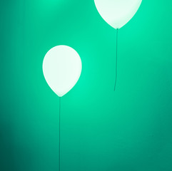 Balloon shape lamp on green wall