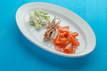 smoked salmon fillet isolated on plate with sauce