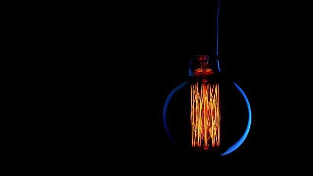 Real Edison light bulb flickering. Vintage filament Edison light bulb.  4K UHD.
