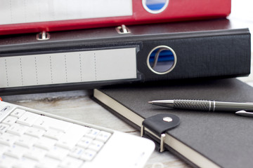 Office workplace with laptop, folders and agenda on wood table