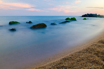 Evening sea with rocks and long exposure
