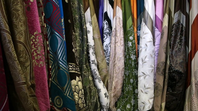 Lot of colorful scarves hanging on the rack