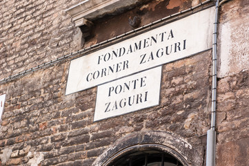 Italian sign post with directions on the wall
