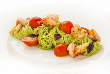 A plate of delicious italian spaghetti with shrimps and cherry