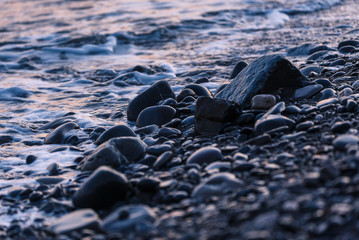 Pebbles on the sea shore at sunset