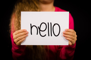 Child holding Hello sign