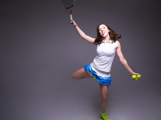 Healthy sporty girl with tennis racket and ball