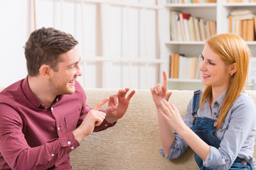 Deaf man with his girlfriend using sign language