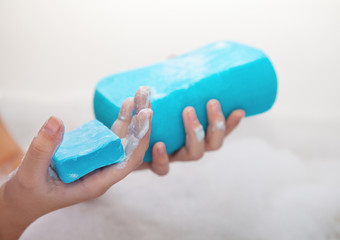 girl holding soap and sponge