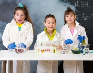 three excited children after chemical experiment