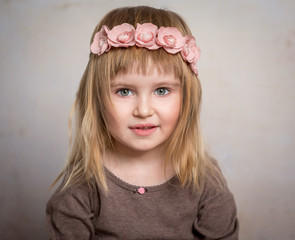 beautiful little girl with flower wreath