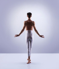 Athletic ballet dancer performing in a studio