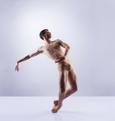 Athletic ballet dancer performing in a studio