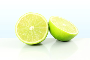 fresh lemon lime citrus fruit cut closeup in sky blue background