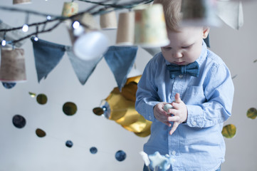 Cute baby boy with candy ball  celebrating birthday.