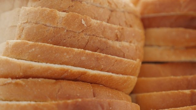 Toast bread slices pile of organic wheat and grain 4K 2160p 30fps UHD footage - Tasty fresh bread for toasting slow tilting 4K 3840X2160 UltraHD video 