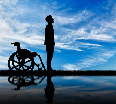 Silhouette of disabled and wheelchair