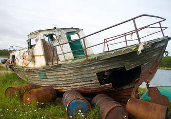 Old whaleboat stranded on shore 