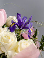 Delicate beautiful bouquet of  iris, roses and other flowers in