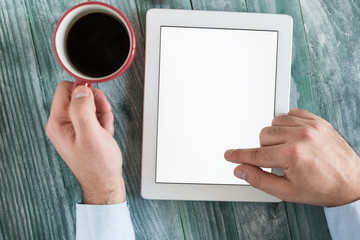 hand using mockup tablet similar to ipad style on wood desk whit