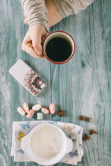 Smartphone and cup of strong coffee on wooden background. Cell p