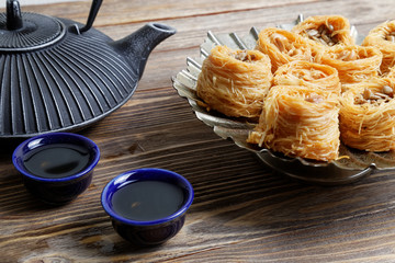 Eastern sweets, teapot and two bowls
