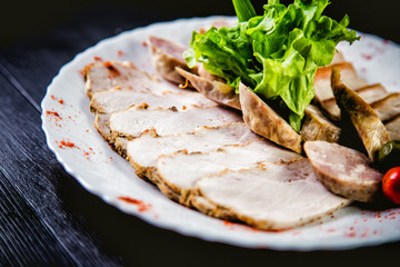 Cutting meat and sausages, spices and herbs, a dish in a restaurant