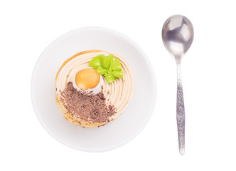 cake on a saucer with a spoon view from above