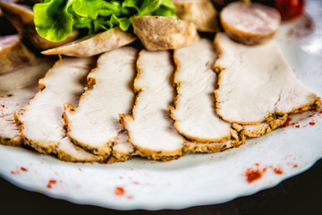 Cutting meat and sausages, spices and herbs, a dish in a restaurant