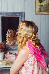 Young beautiful woman in angel costume