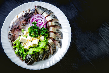 chopped roasted and pickled herring with onions cheese and herbs