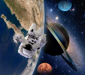 Fototapety  Astronaut spaceman moon saturn planet spacewalk earth outer space walk galaxy. Elements of this image furnished by NASA.