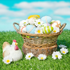 decorated easter eggs in the basket with daisies