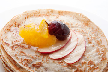 Pancakes with fruit and syrup. Pancake Day. Shrovetide.