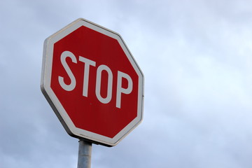 Stop sign on cloudy sky