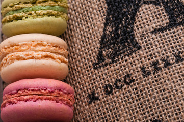 Close up macaroons on the jute tablecloth with space for text