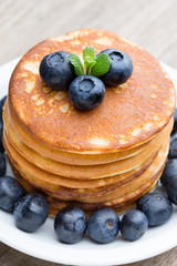 Stack of pancakes with blueberry and fresh berry.