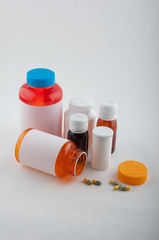 Different color pharmaceutical bottles and pills