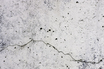 Texture di sfondo di un  muro, in cemento, con crepa che scorre orizzontalmente