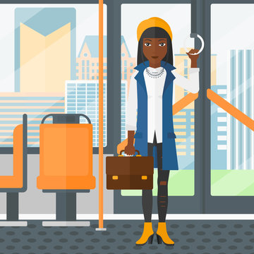 Woman standing inside public transport.