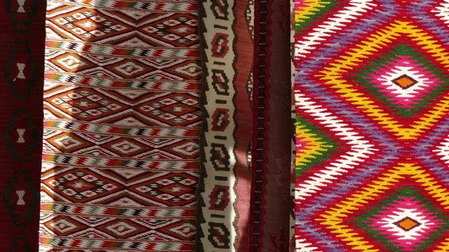 Hand made rug swinging and moving in the wind. Colorful surface, texture of traditional woolen and vintage hand made rug.