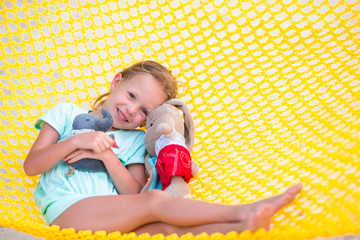 Adorable little girl relaxing in hammock