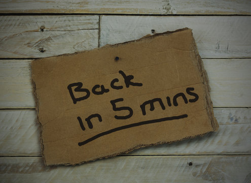 Cardboard sign on a wooden background