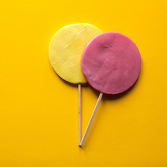 Two Lollipops on yellow