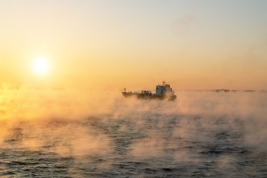  The ship sails at dawn in the fog of the cold winter sea.Estoni