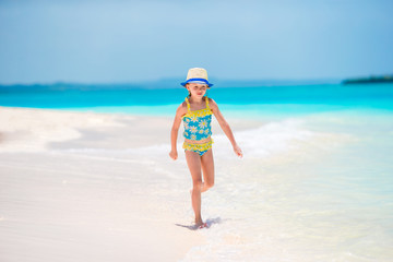 Fototapeta na wymiar Adorable little girl at beach during summer vacation