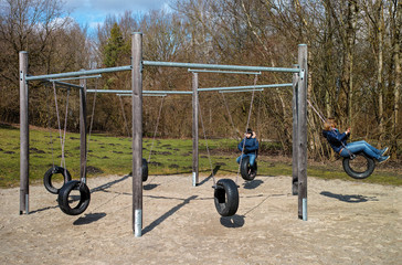 Children s playground.Mother and son playing on a playground made with Recycled Tires. Munich,...